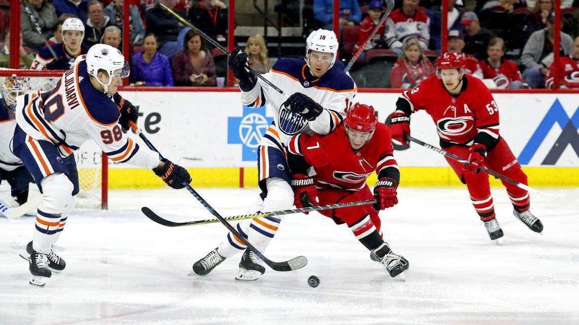 The Canes' Derek Ryan (7) and Jeff Skinner (53) battle the Oilers' Jesse Puljujarvi (98) and Ryan Strome (18) for the puck during the second period of an NHL game played between the Carolina Hurricanes and the Edmonton Oilers at PNC Arena in Raleigh on Tuesday, March 20, 2018.
