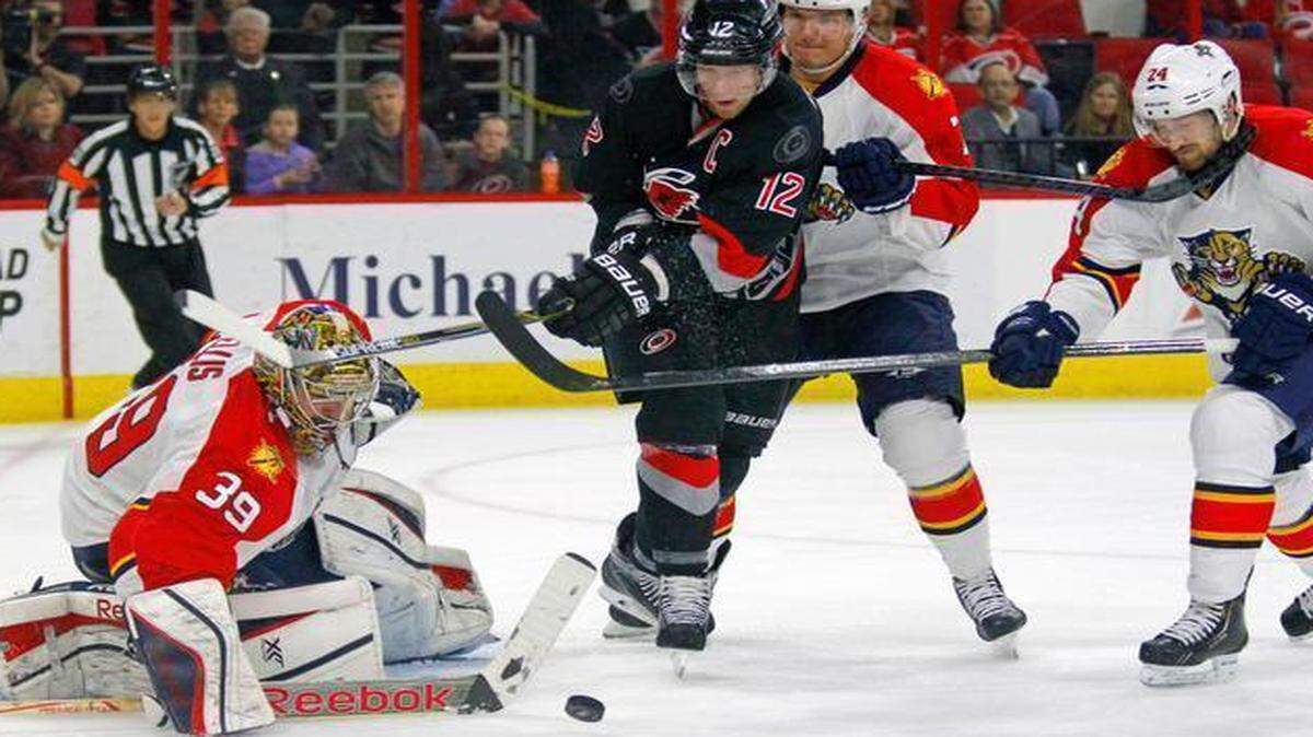 
The Canes Eric Staal (12) swings at the puck as he tries to score agains the Florida Panthers' Dan Ellis (39), Dmitry Kulikov (7) and Brad Boyes (24) during the first period of an NHL game played between the Carolina Hurricanes and the Florida Panthers at PNC Arena in Raleigh, N.C. on March 14, 2015.
