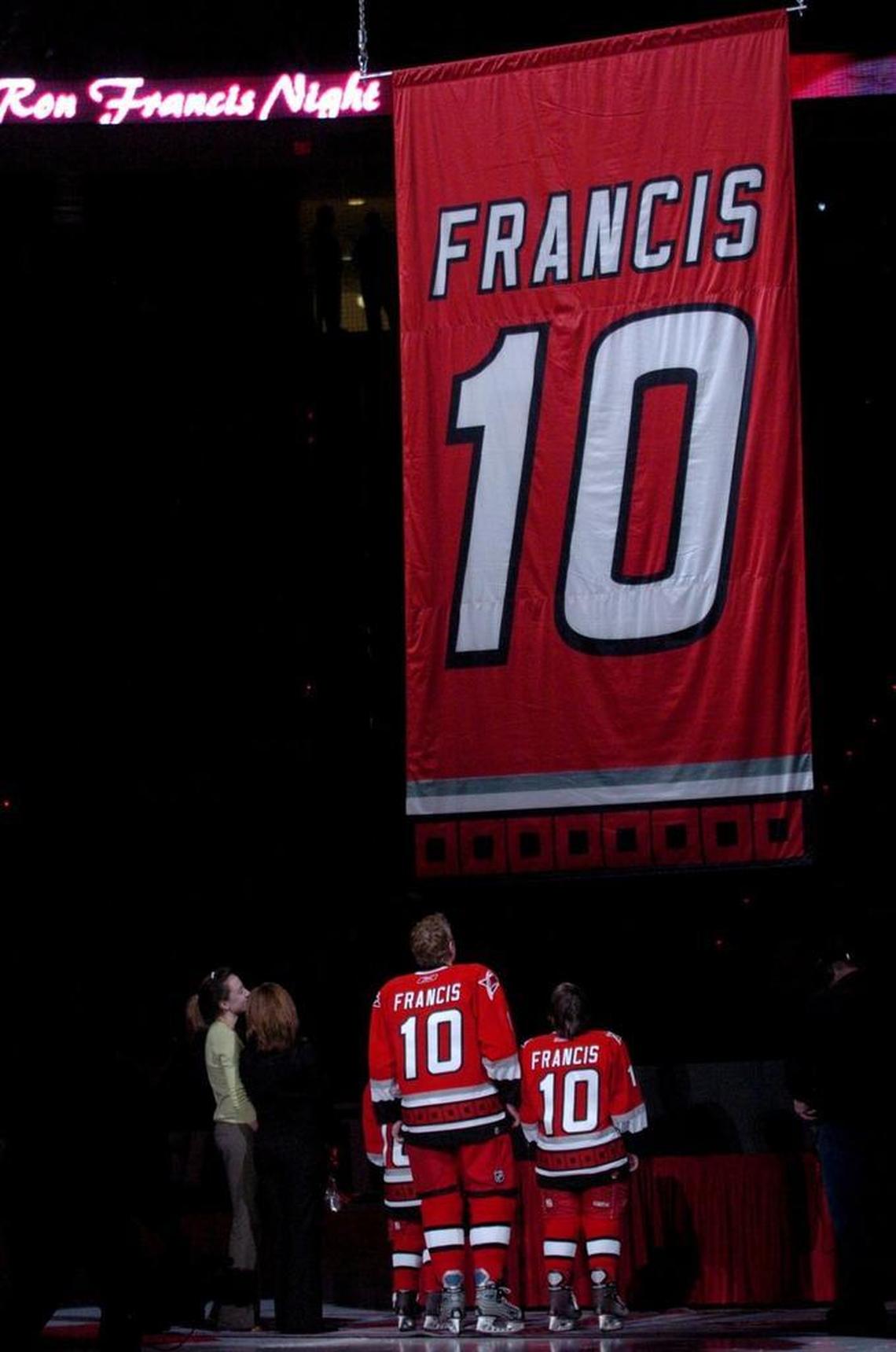 Former Canes captain Ron Francis, 10, and his family watch as a banner bearing his number is raised to the rafters in retirement during a ceremony held before an NHL game played between the Carolina Hurricanes and the Atlanta Thrashers at the RBC center in Raleigh Jan. 28, 2006. His jersey was retired in honor of his career.