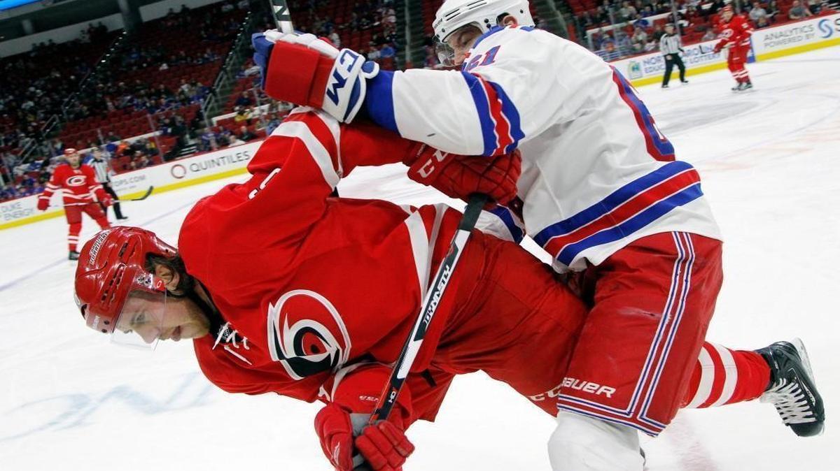 The Rangers’ Rick Nash (61) hits the Canes Elias Lindholm during the first period Friday at PNC Arena in Raleigh,.