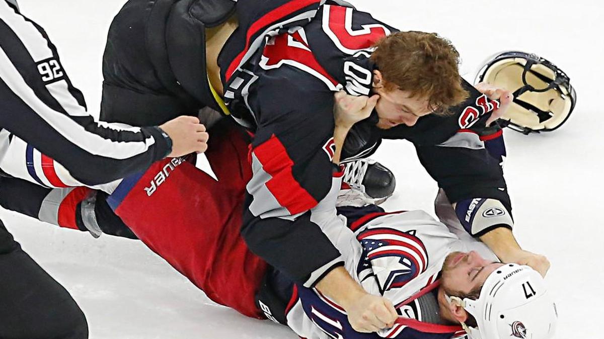 The Carolina Hurricanes' Brad Malone (24) body slams the Columbus Blue Jackets' Brandon Dubinsky (17) as they fight during the third period of an NHL game played between the Carolina Hurricanes and the at the Columbus Blue Jackets at PNC Arena in Raleigh, N.C. on Jan. 8, 2016. Both players were penalized on the play. The Canes beat the Blue Jackets 4-1.
