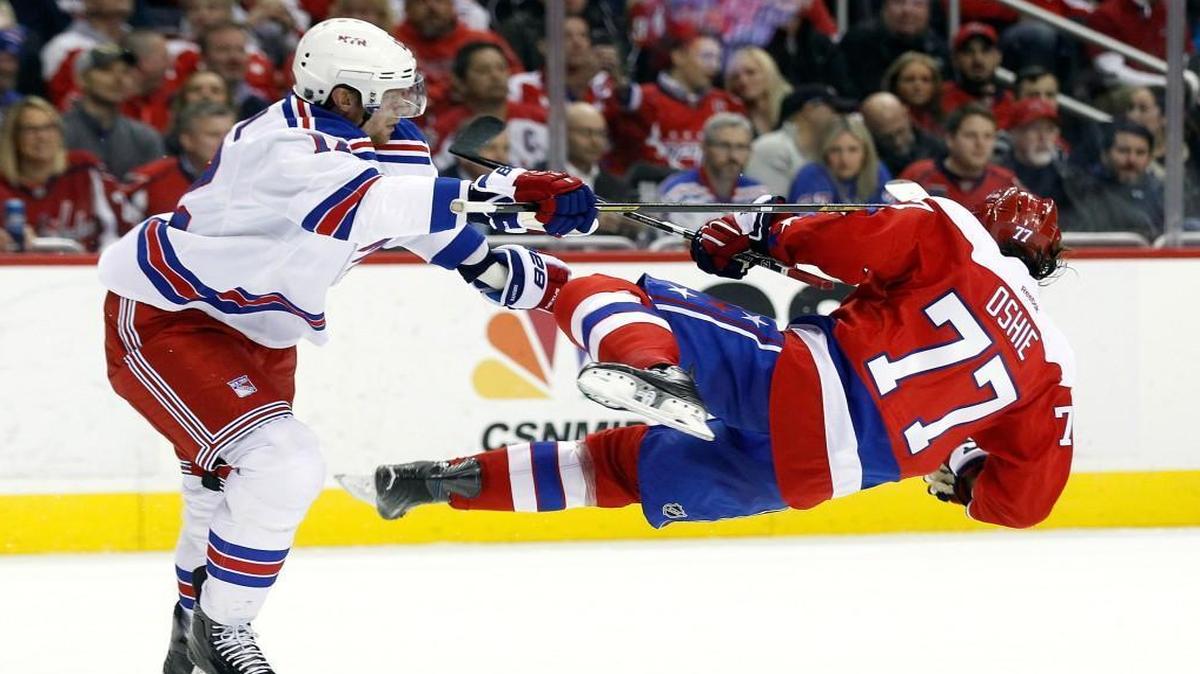 Eric Staal #12 of the New York Rangers checks T.J. Oshie #77 of the Washington Capitals during the second period at the Verizon Center on March 4, 2016 in Washington, DC.