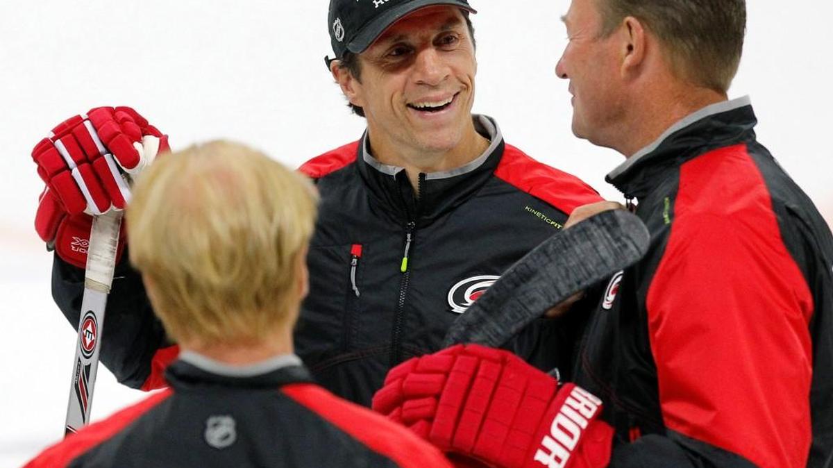 Hurricanes’ assistant coaches Glen Wesley, left, Rod Brind’Amour, center, and Steve Smith enjoy a laugh on July 6, 2016.