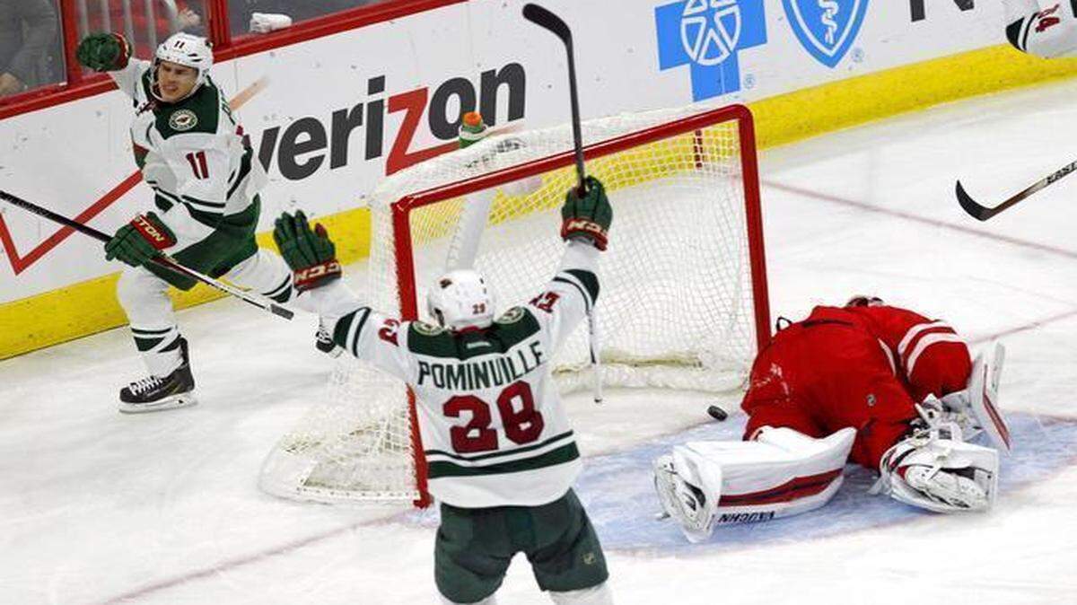
The Minnesota Wild's Zach Parise (11) celebrates his goal with Jason Pominville (29) after he scored against Canes goalie Anton Khudobin (31) during the third period at PNC Arena in Raleigh.
