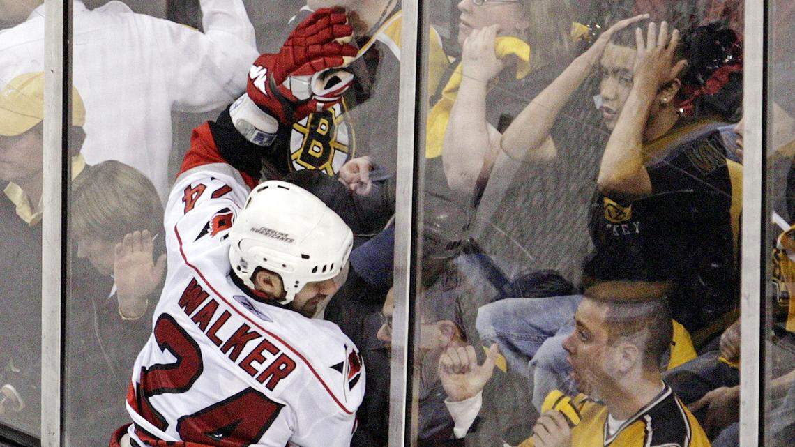 The Bruins’ fans react as the Carolina Hurricanes’ Scott Walker (24) throws himself against the glass after he scored the game-winning goal during overtime action of Game 7 in 2009.