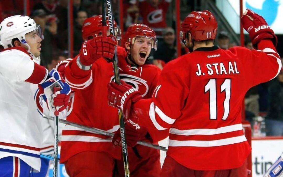 The Carolina Hurricanes' Joakim Nordstrom (42) celebrates with Andrej Nestrasil (15) and Jordan Staal (11) after he scored against the Montreal Canadiens' Alexei Emelin (74) and Mike Condon (39) and Alexei Emelin (74) during the second period at PNC Arena in Raleigh.