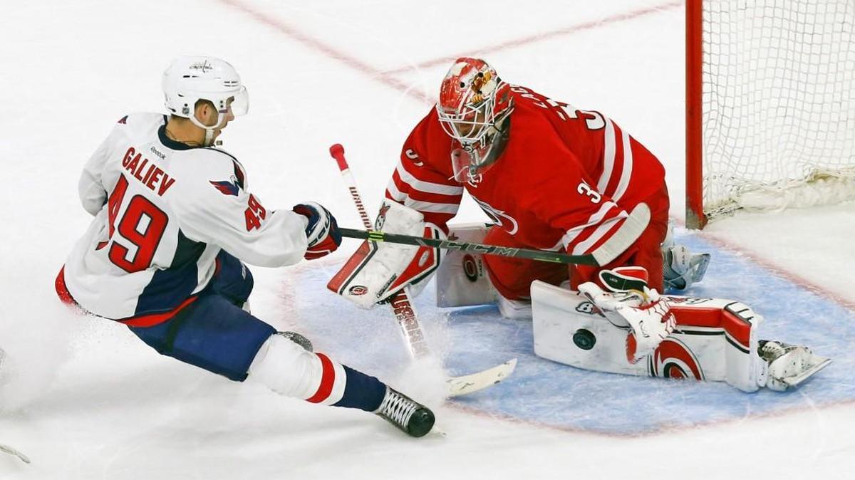 
The Carolina Hurricanes' Eddie Lack (31) defends the net against the Washington Capitals' Stanislav Galiev (49) during a preseason NHL game played between the Carolina Hurricanes and the Washington Capitals at PNC Arena in Raleigh, N.C. on 2015.
