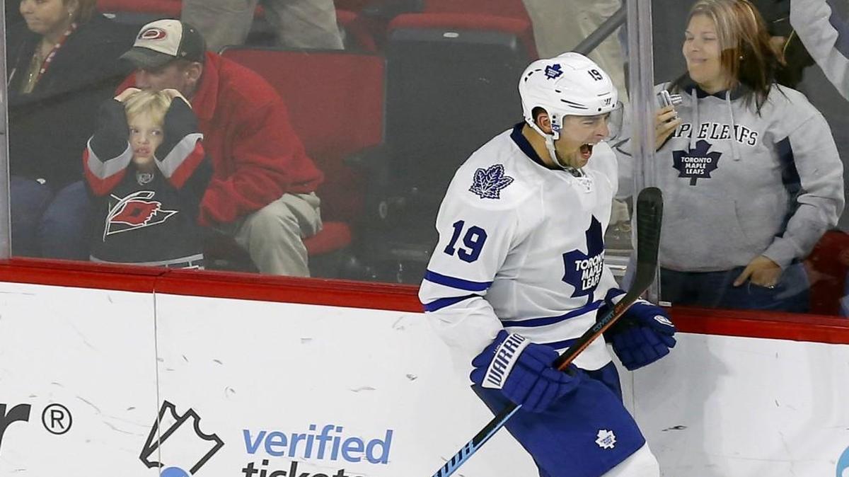 The Maple Leafs’ Joffrey Lupul and a young Canes fan, left, have very different reactions after he scored the winning goal during the shootout at PNC Arena in Raleigh.
