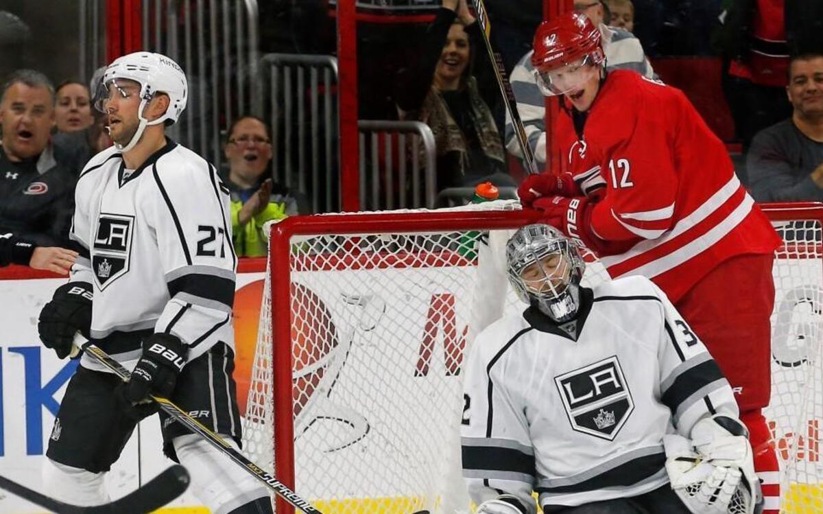 The Kings Alec Martinez (27), Jonathan Quick (32) and the Canes Eric Staal (12) react very differently after Martinez knocked the puck into his own net for a Hurricanes goal during the second period of an NHL game played between the Carolina Hurricanes and the Los Angeles Kings at PNC Arena in Raleigh, N.C. on Nov. 22, 2015. The Canes Justin Faulk was credited with the goal. The Canes beat the Kings 4-3.