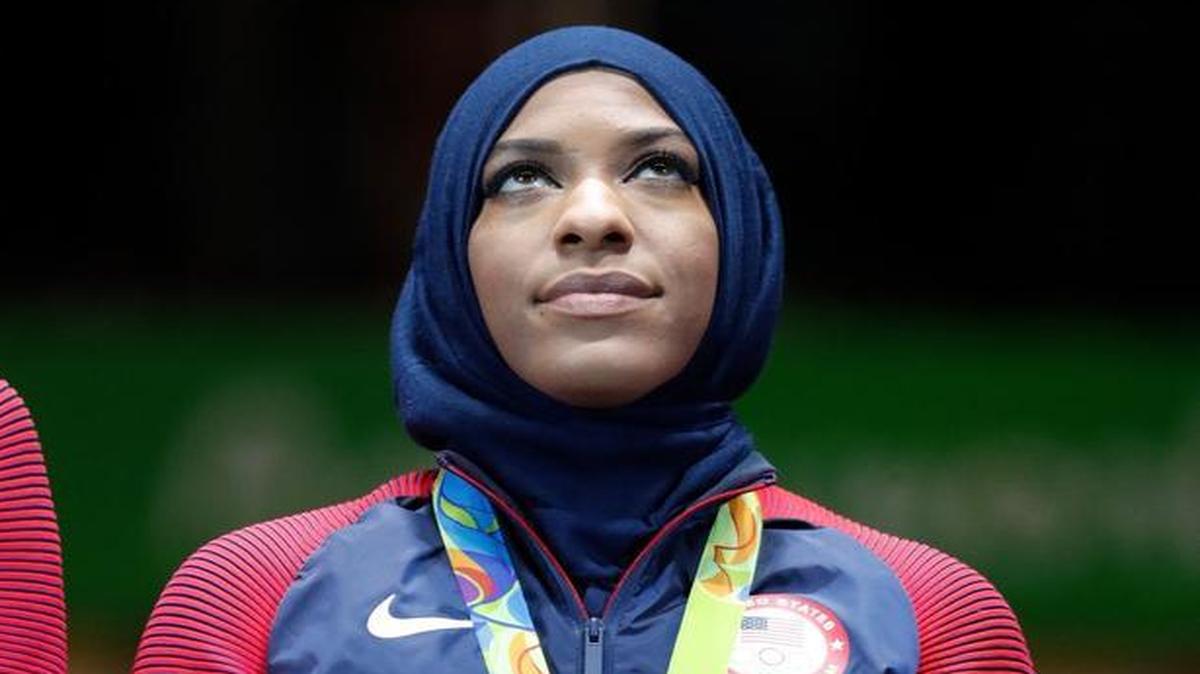 Ibtihaj Muhammad of the United States poses with her bronze medal on the podium after the women’s team sabre fencing event at the 2016 Summer Olympics in Rio de Janeiro, Brazil, on Aug. 13. (AP Photo/Vincent Thian)