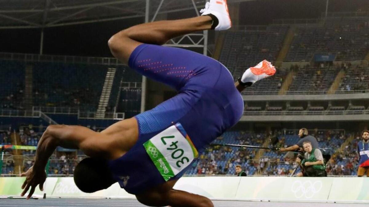 United States' Ronnie Ash falls after crossing the line of the men's 110-meter hurdles final during the athletics competitions of the 2016 Summer Olympics at the Olympic stadium in Rio de Janeiro, Brazil, Tuesday, Aug. 16, 2016.