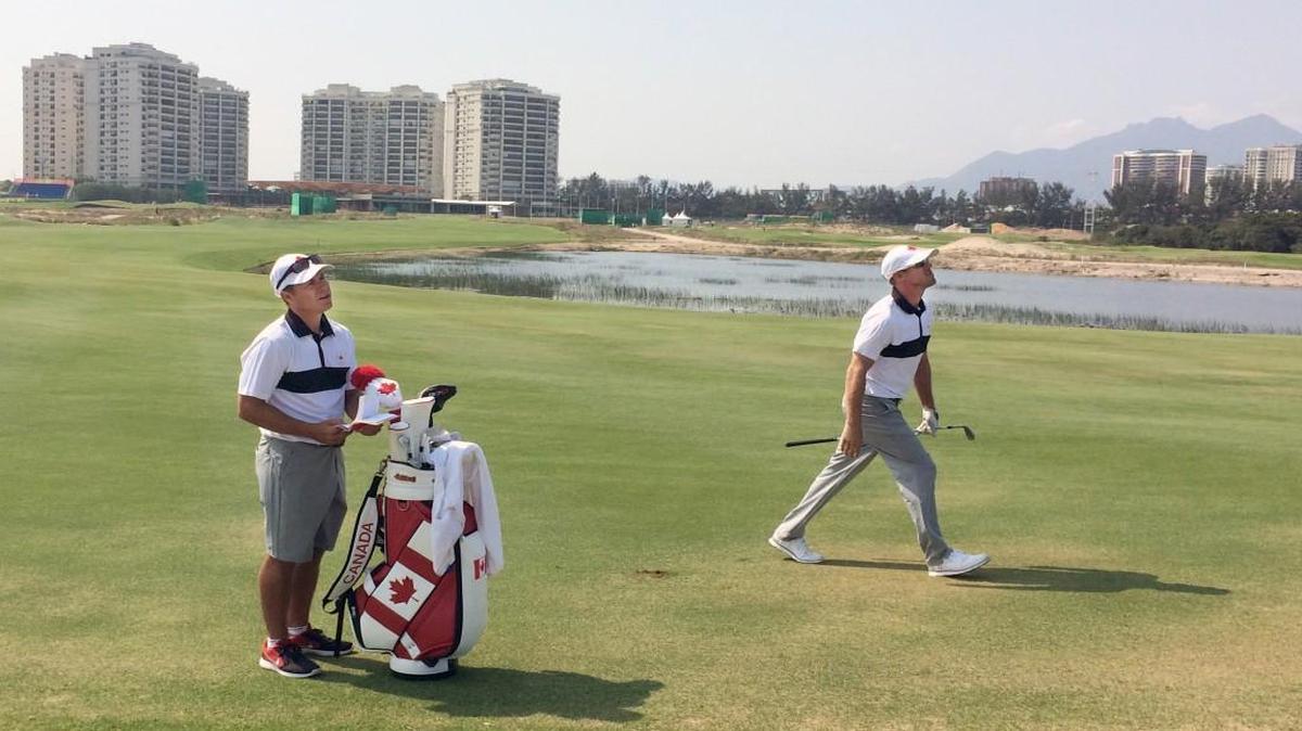 Former Carolina Hurricane Ray Whitney caddies for Graham DeLaet, the Canadian golfer, during the Olympics.