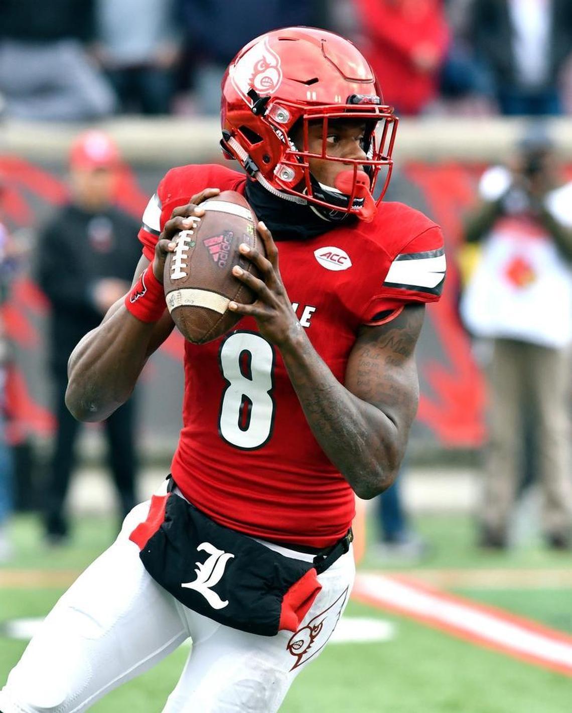 In this Nov. 26, 2016, photo, Louisville’s Lamar Jackson (8) looks for an open receiver during the first half Kentucky in Louisville, Ky.