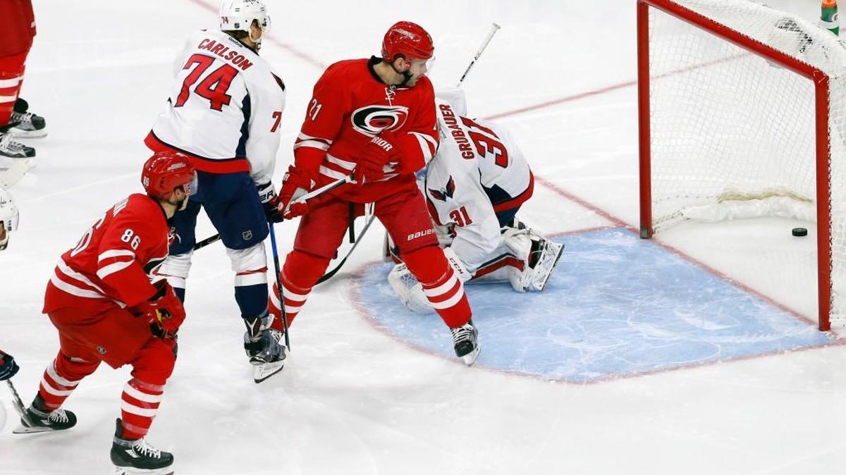 The Canes Teuvo Teravainen (86) watches his shot go into the net past the Washington Capitals' John Carlson (74) and Philipp Grubauer (31) while the Canes' Lee Stempniak (21) looks on.
