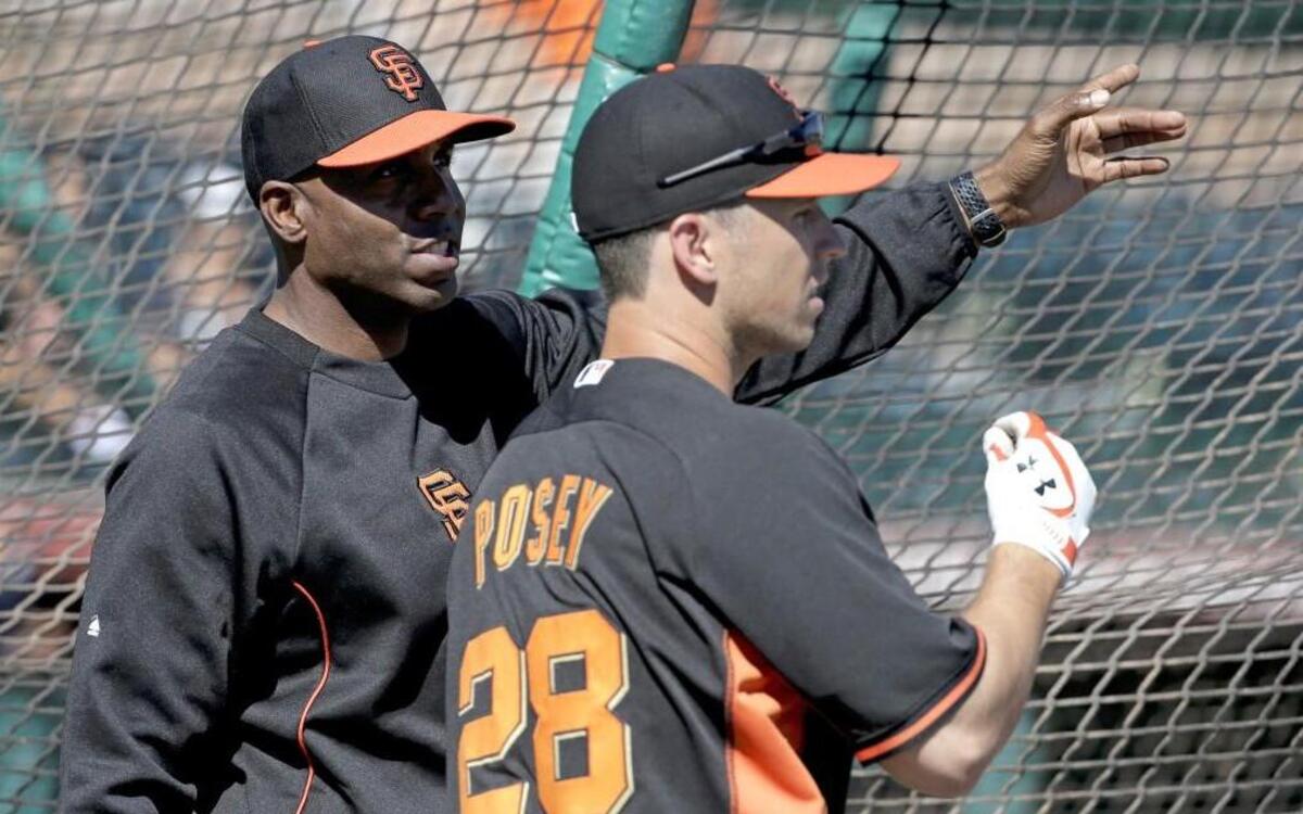 San Francisco Giants former player Barry Bonds, left, watches Buster Posey hit during batting practice before a spring training baseball game in Scottsdale, Ariz., Monday, March 10, 2014. Bonds starts a seven day coaching stint Monday.
