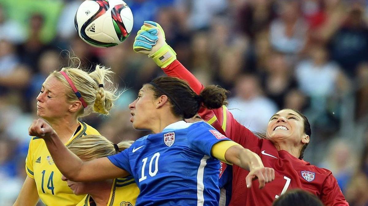 
USA goalkeeper Hope Solo, right, punches the ball away as Sweden's Amanda Ilestedt, left, oes for a header during their Group D match of the 2015 FIFA Women's World Cup at the Winnipeg Stadium on June 12, 2015, in Winnipeg, Manitoba. The match ended 0-0. 
