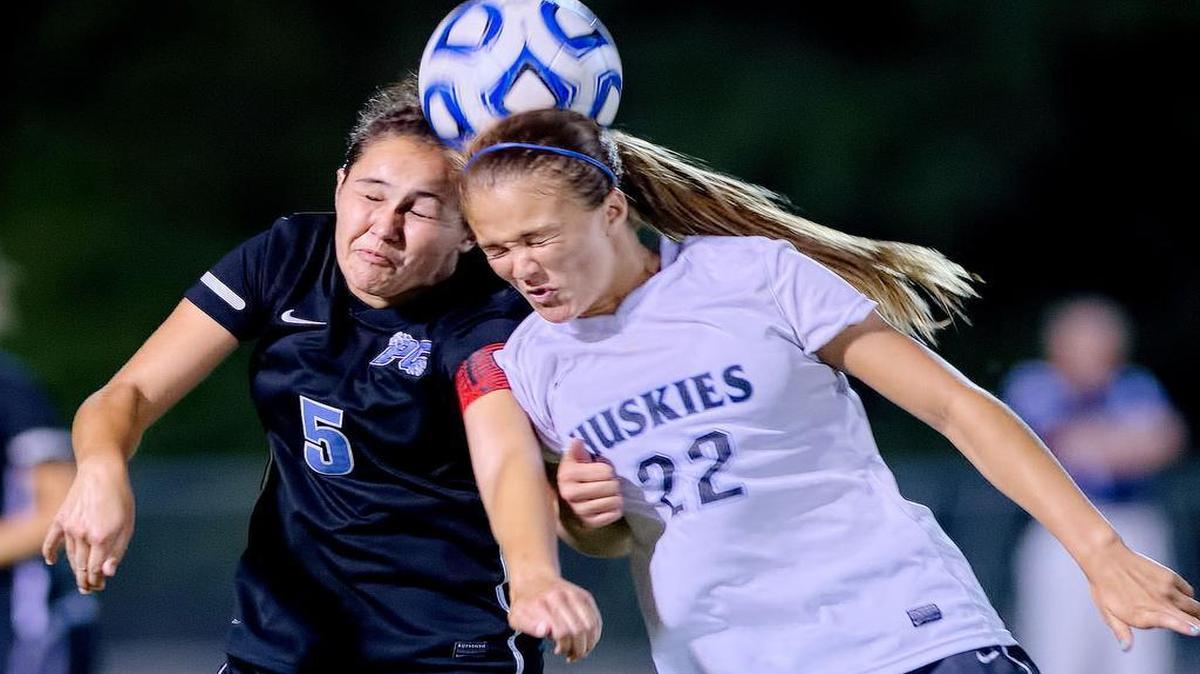 
Panther Creek's Rachael Everhart (5) and Hough's Ashley Johnson (22) go for a header during 2014 the NCHSAA 4A Women's Championship Soccer Game in Raleigh, N.C. Hough won the game, 1-0 (OT). 
