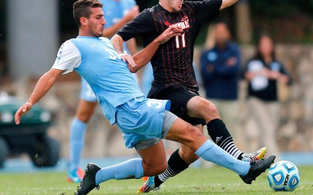 
UNC midfielder Raby George (33) fights for the ball with Louisville midfielder Ben Strong (11) during the quarterfinals of the ACC Men's Soccer Championship on Sunday, Nov. 9, 2014, in Chapel Hill.
