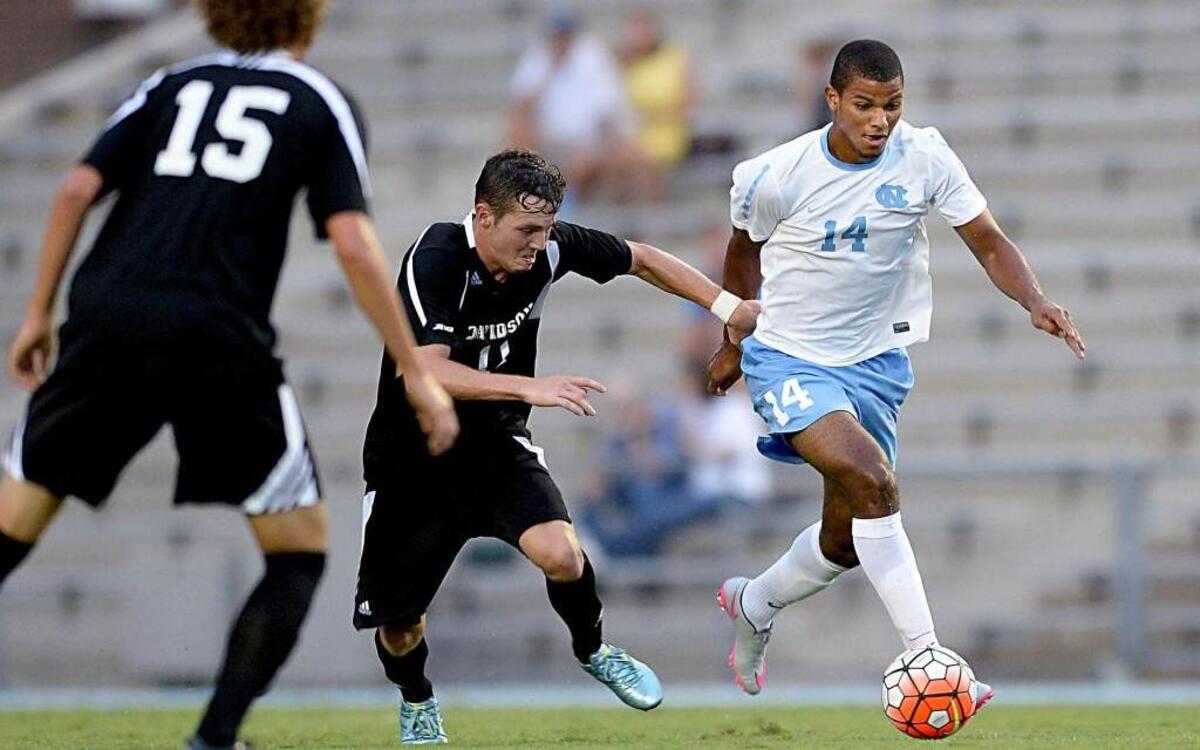 
UNC's Omar Holness, right, works against Davidson defenders at Fetzer Field in Chapel Hill, N.C. on Wednesday, August 19, 2015.
