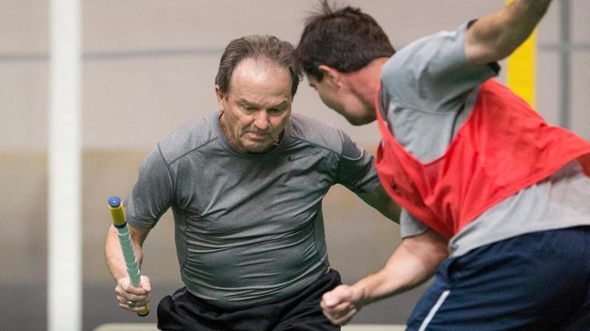 
UNC-Chapel Hill women's soccer coach Anson Dorrance, left, blocks a shot during a game of Noon Ball recently at the Eddie Smith Field House on campus. 
