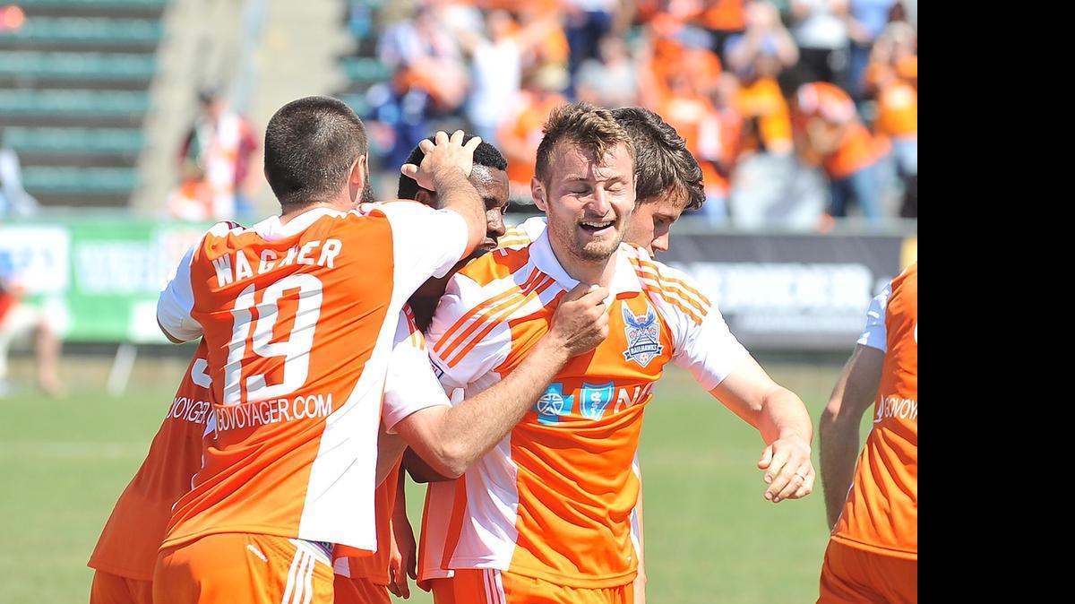 
Carolina RaiHawks' Blake Wagner (19) and teammates congratulate Simone Bracalello (7) after his score late in the second half. The Carolina RailHawks took on the Ottawa Fury in their season opener at the WakeMed Soccer Park in Cary, N.C. on April 4, 2015.
