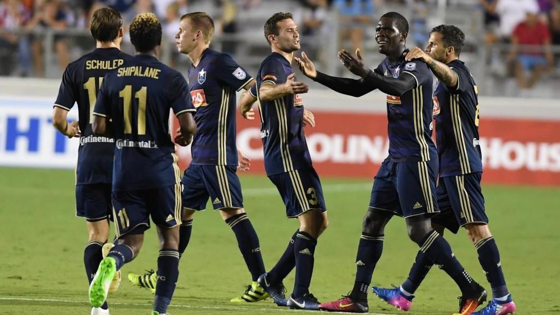 Lance Laing, second from right, of North Carolina F.C. celebrates along his teammates after scoring against the Houston Dynamo in June.