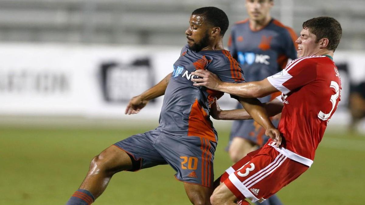 Carolina's Jon Orlando (20) keeps the ball from New England's Donnie Smith (33) during the second half of New England Revolution's 1-0 overtime victory over the Carolina RailHawks at WakeMed Soccer Park in Cary, N.C., Wednesday, June 15, 2016.