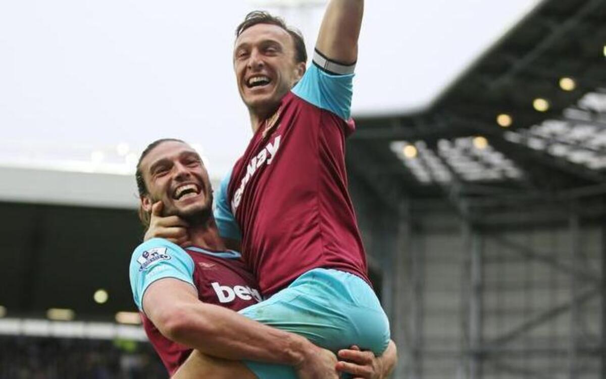 Mark Noble, right, of West Ham United celebrates scoring his team’s third goal with his teammate Andy Carroll, left, during the Barclays Premier League match between West Bromwich Albion and West Ham United at The Hawthorns on April 30, 2016, in West Bromwich, England.