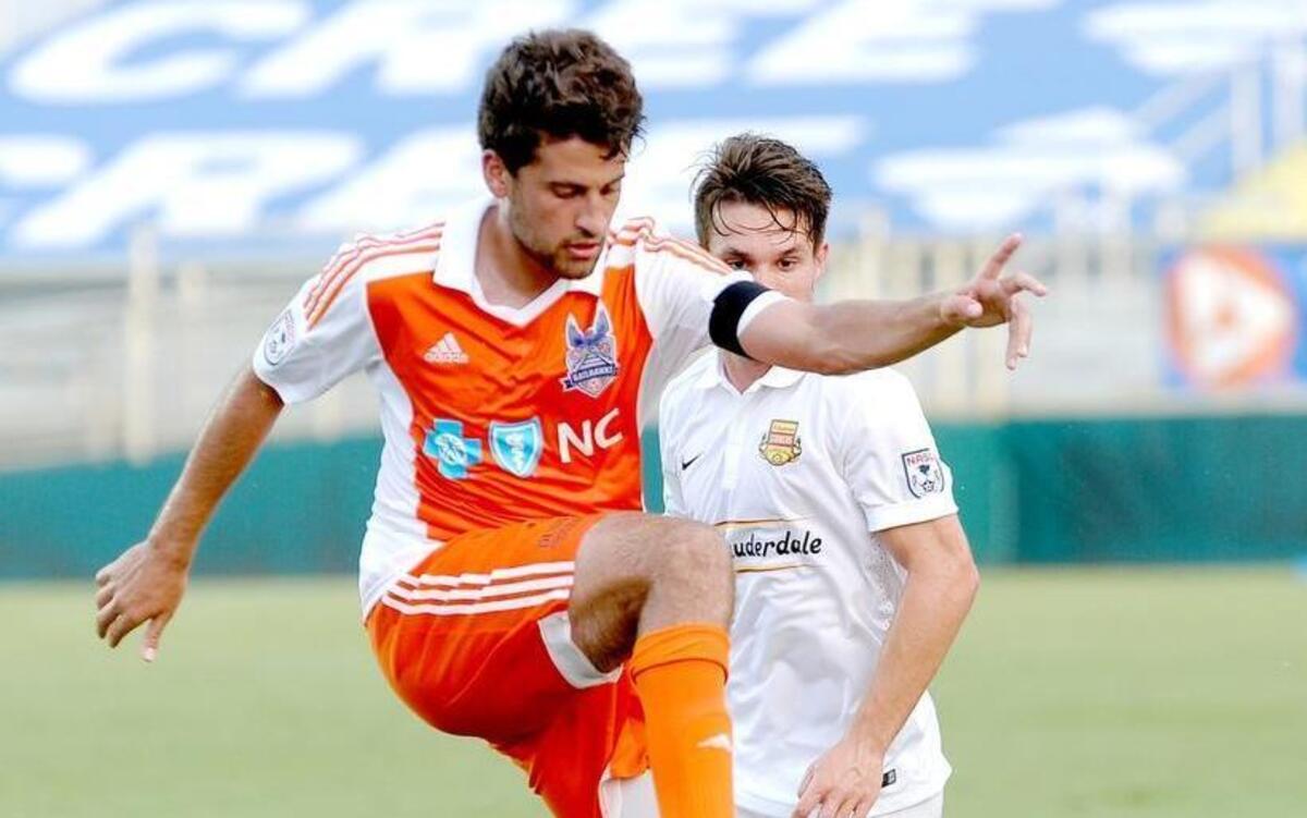 The Railhawks’ Nazmi Albadawi (left) controls the ball ahead of Ft. Lauderdale's Victor Pagliari Giro during the soccer match between the Ft. Lauderdale Strikers and the Carolina Railhawks in Cary on Wednesday, July 8, 2015.