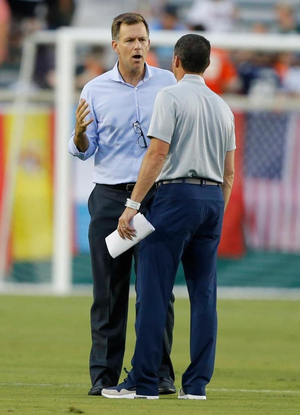 Curt Johnson, president and general manager of the Carolina RailHawks, left, talks with New England Revolution coach Jay Heaps before a weather delay at Carolina RailHawks against the New England Revolution at WakeMed Soccer Park in Cary on June 15, 2016.