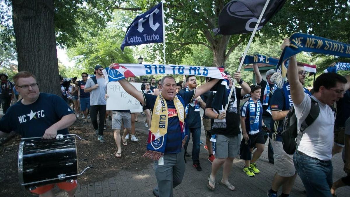 Triangle soccer fans march through Moore Square to a rally at City Market to promote Raleigh as an MLS expansion city on Wednesday.