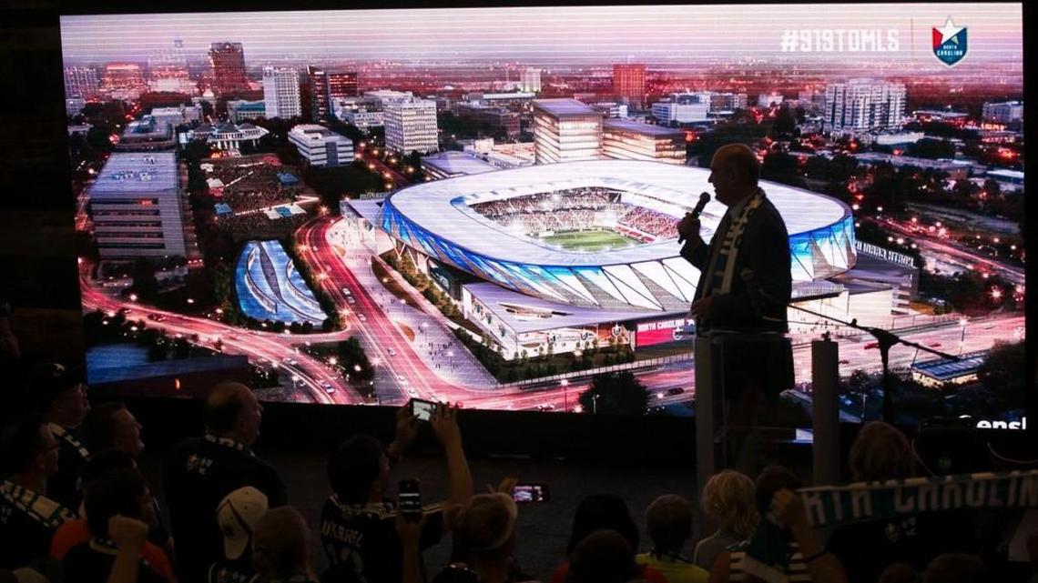 North Carolina FC president Steve Malik unveils a rendering of a proposed $150 million stadium and entertainment complex during a rally of soccer fans at City Market to promote Raleigh as a MLS expansion city on Wednesday.