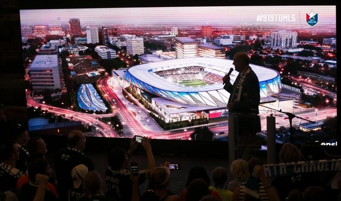 North Carolina Football Club president Steve Malik unveils a rendering of a proposed $150 million stadium and entertainment complex during a rally of soccer fans at City Market to promote Raleigh as a MLS expansion city on July 19, 2017.