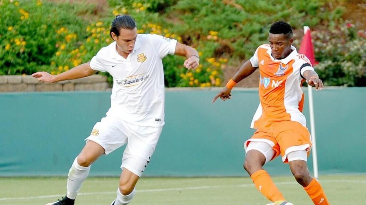 Fort Lauderdale's Karsten Smith (left) and the Railhawk's Tiyi Shipalane battle for the ball during the soccer match between the Ft. Lauderdale Strikers and the Carolina Railhawks in Cary on Wednesday, July 8, 2015.