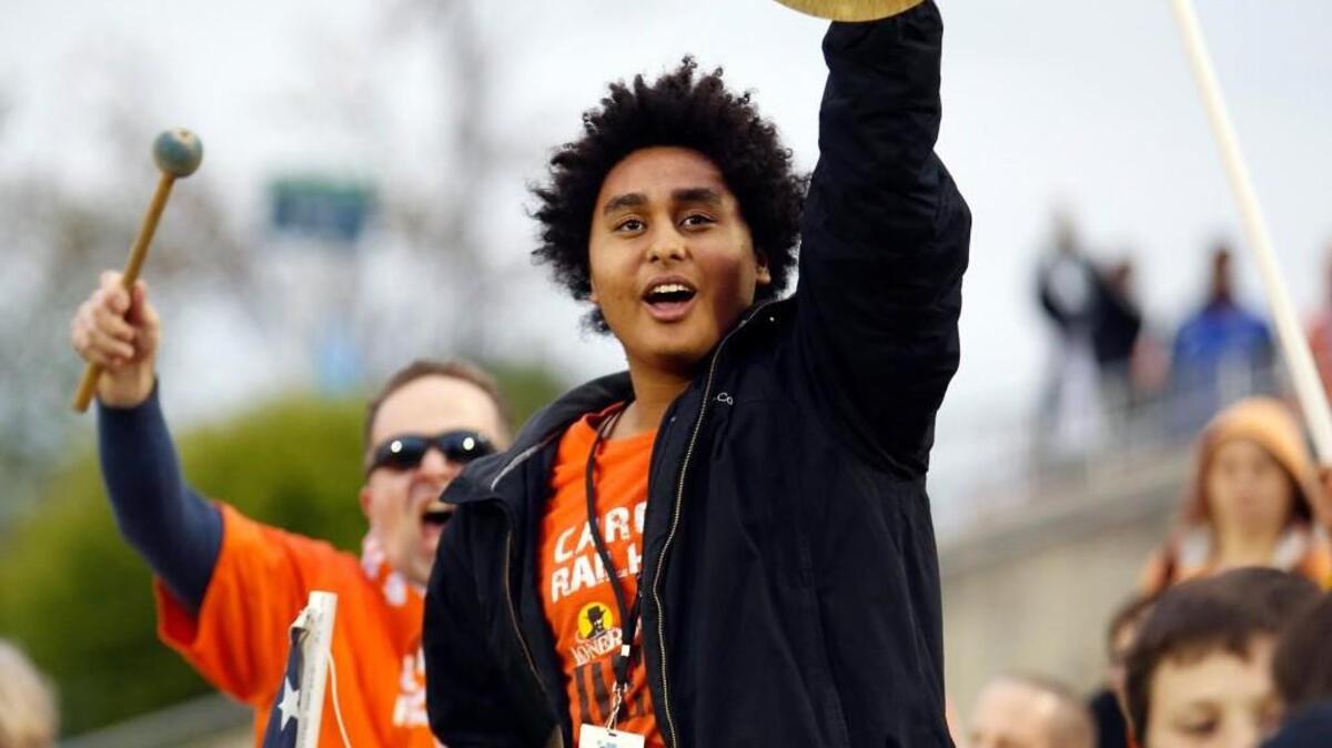 Justin Mayo, center, and Dave Warner lead the cheers with crash cymbals and a bass drum from the fans in section 309 during the Carolina RailHawks' season-opening home game against the Ft. Lauderdale Strikers at WakeMed Soccer Park in Cary on Saturday, April 19, 2014.