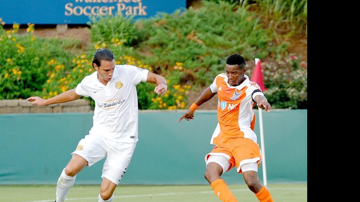 
Fort Lauderdale’s Karsten Smith (left) and the RailHawks’ Tiyi Shipalane battle for the ball during the soccer match between the Fort Lauderdale Strikers and the Carolina RailHawks in Cary on Wednesday, July 8, 2015.
