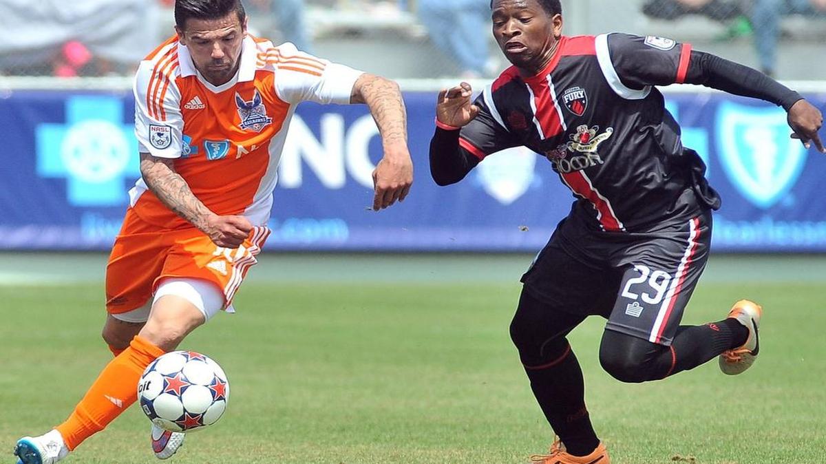 
Carolina RailHawks' Nacho Novo (10) controls the ball while defended by Ottawa's Mike Randolph (29) during the first half. The Carolina RailHawks took on the Ottawa Fury in their season opener at the WakeMed Soccer Park in Cary, N.C. on April 4, 2015.
