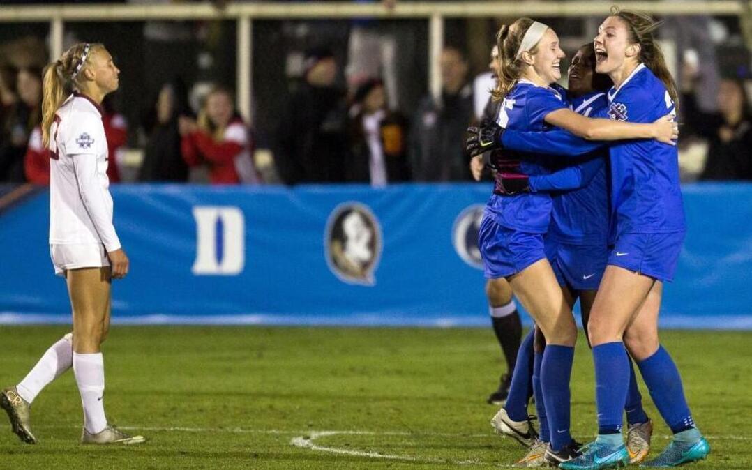 Duke’s Kara Wilson, third from right, Toni Payne, second from right, and Duke’s Malinda Allen, right. celebrate after Payne scored a goal to seal a win over Florida State in an NCAA Women's College Cup soccer semifinal in Cary, N.C., Friday, Dec. 4, 2015. Duke won the game 2-0. (AP Photo/Ben McKeown)