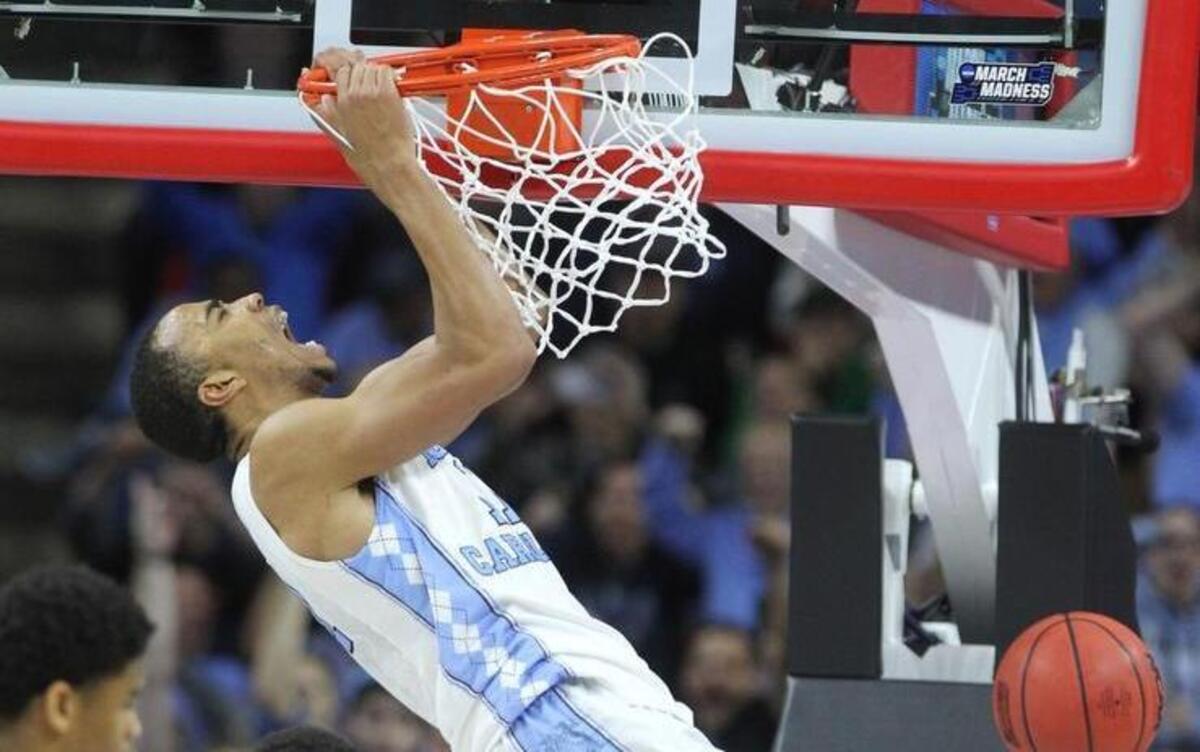 North Carolina's Brice Johnson (11) screams after slamming in two during the second half of UNC's 85-66 victory over Providence in the second round of the NCAA tournament at PNC Arena.
