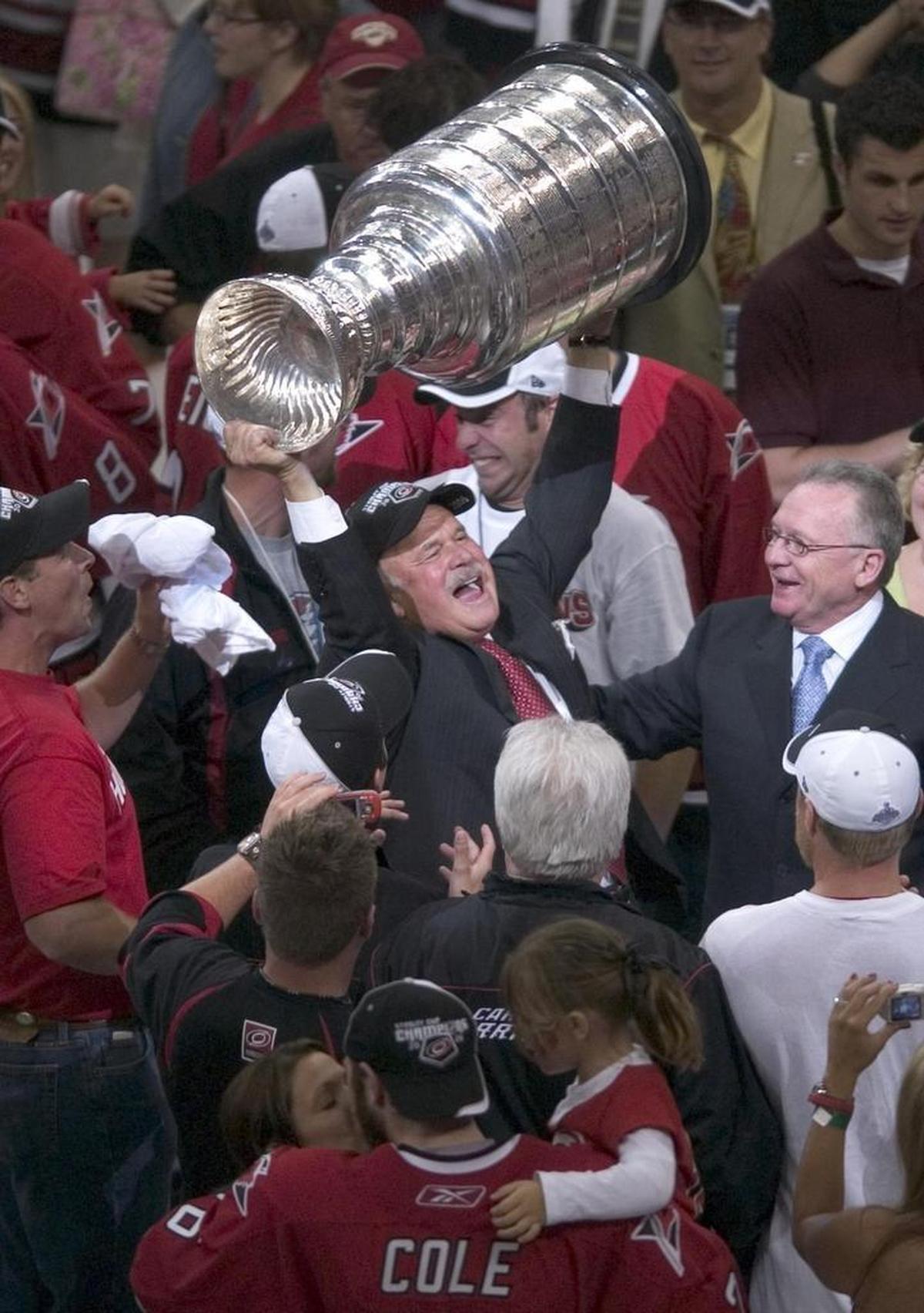 Carolina Hurricanes owner Peter Karmanos hoists the Stanley Cup after the Canes defeated Edmonton 3-1 on Monday June 19, 2006 in game seven of the Stanley Cup finals at the RBC Center. Robert Willett