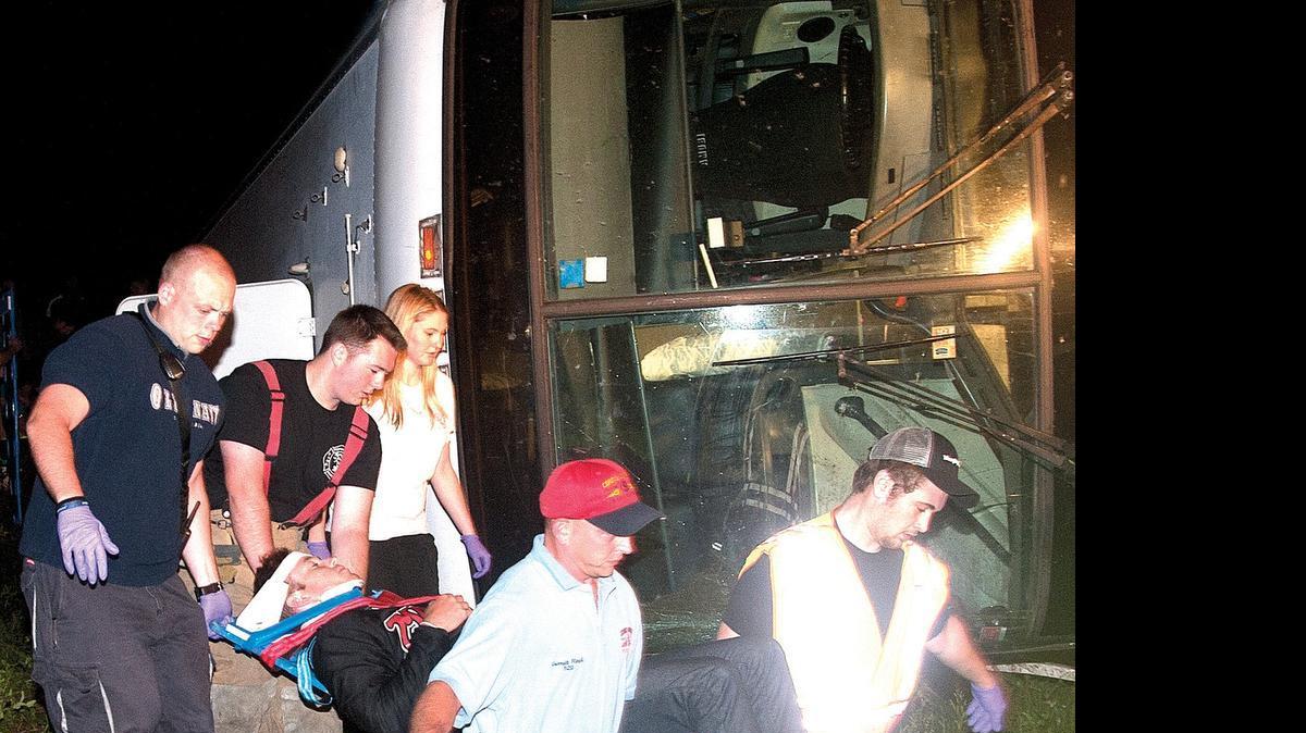 
Chadbourn-Klondyke Fire & Rescue personnel carry an injured passenger from a charter bus to an ambulance. There were 30 to 35 people on board and eight or nine taken to Columbus Regional Medical Center with non-life threatening injuries. 
