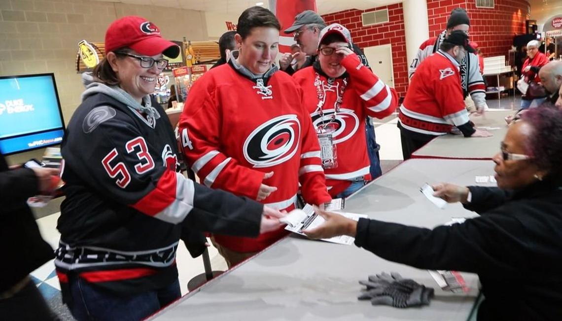 Happy Hurricanes fans get their tickets upgraded from the upper deck to the lower deck for no charge before an NHL game played between the Carolina Hurricanes and the Ottawa Senators at PNC Arena in Raleigh, N.C. on Jan. 30, 2018. It was a promotion by the team to give the fans a better seat.