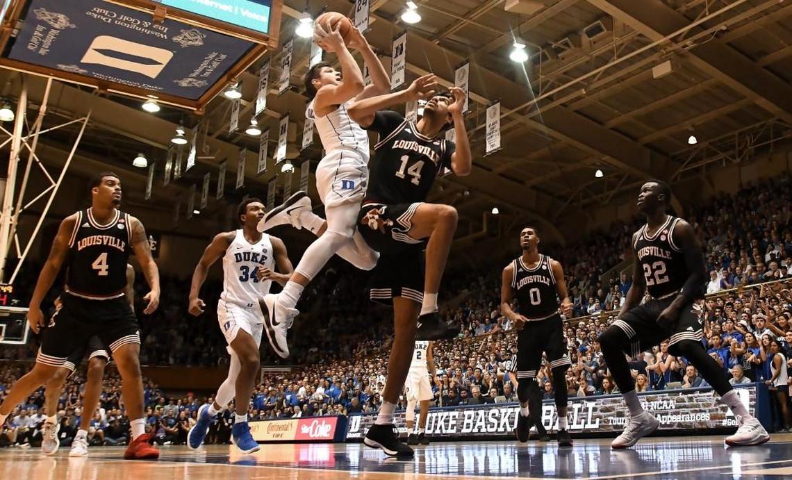 Duke guard Grayson Allen (3) goes in to score in the first half as Louisville forward Anas Mahmoud (14) defends. Allen scored 28 points in the win. Duke defeated Louisville 82-56 at Cameron Indoor Stadium In Durham, N.C. Wednesday, Feb. 21, 2018