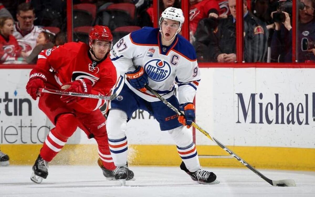 Edmonton Oilers’ Connor McDavid controls the puck away from Carolina Hurricanes’ Noah Hanifin at PNC Arena in Raleigh.