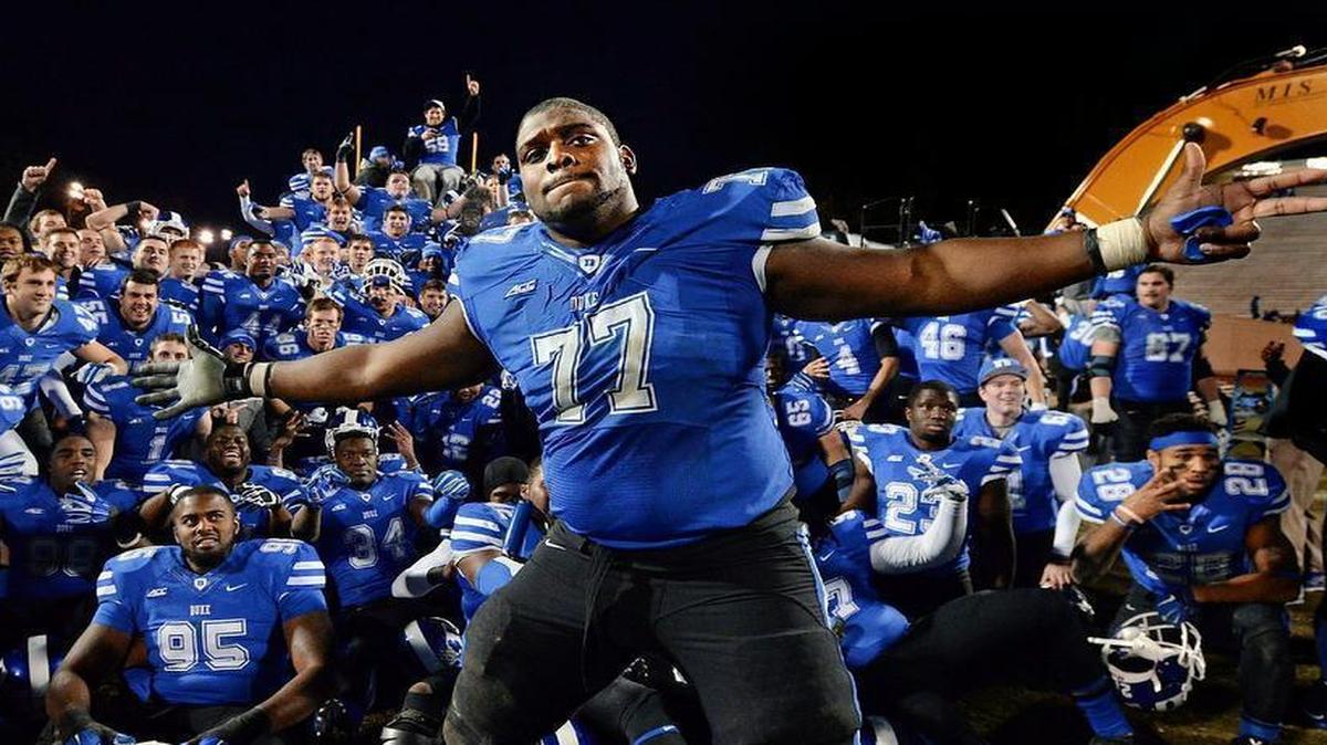 
Duke guard Laken Tomlinson (77) photo bombs a group shot as the Blue Devil football team poses with heavy equipment prior to the groundbreaking ceremony after Duke beat Wake Forest 41-21 at Wallace Wade Stadium Saturday, Nov. 29, 2014 in Durham, NC.
