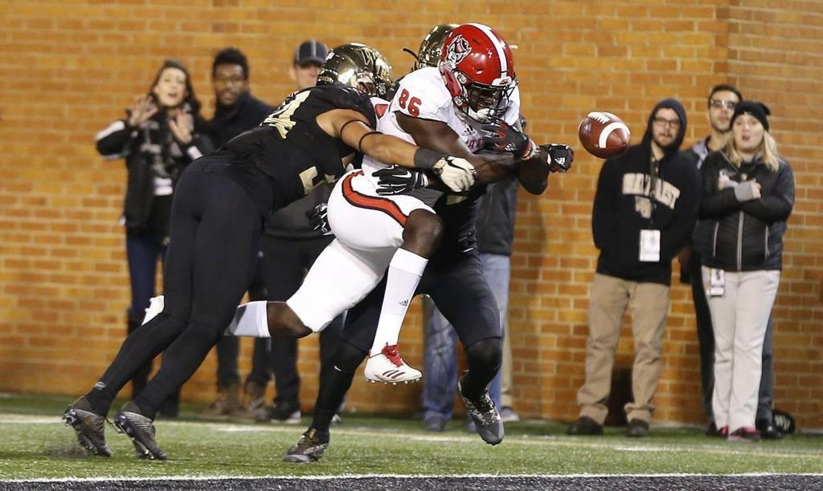 N.C. State wide receiver Emeka Emezie (86) fumbles the ball before crossing into the end zone as he is hit by Wake Forest's Demetrius Kemp (34), left, and Ja'Sir Taylor (24) during the second half of Wake Forest's 30-24 victory over N.C. State at BB&T Field in Winston-Salem, N.C., Saturday, Nov. 18, 2017.