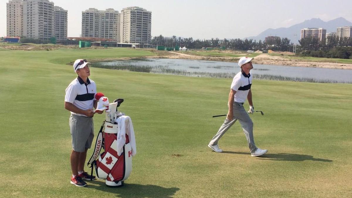 Former Carolina Hurricane Ray Whitney caddies for Graham DeLaet, the Canadian golfer, during the Olympics.