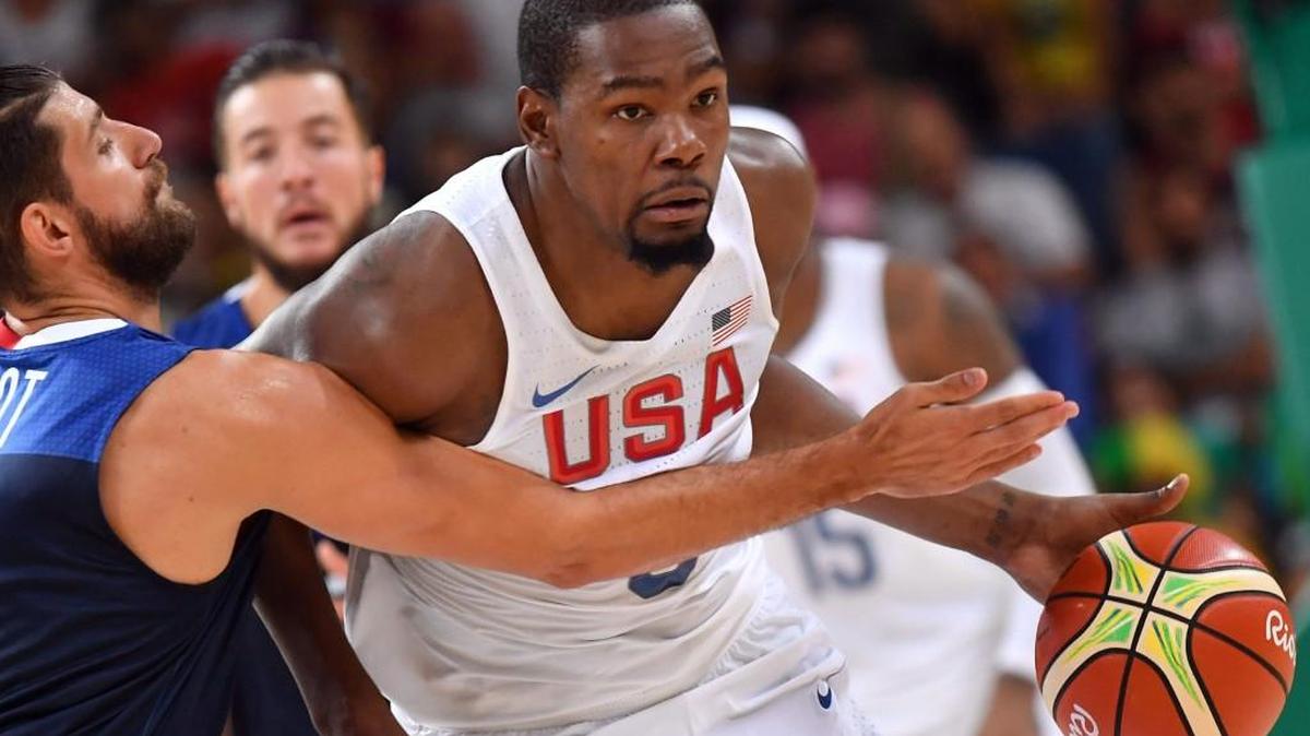 Team USA’s Kevin Durant drives around France point guard Antoine Diot during a Group A game on Sunday in Rio de Janeiro.