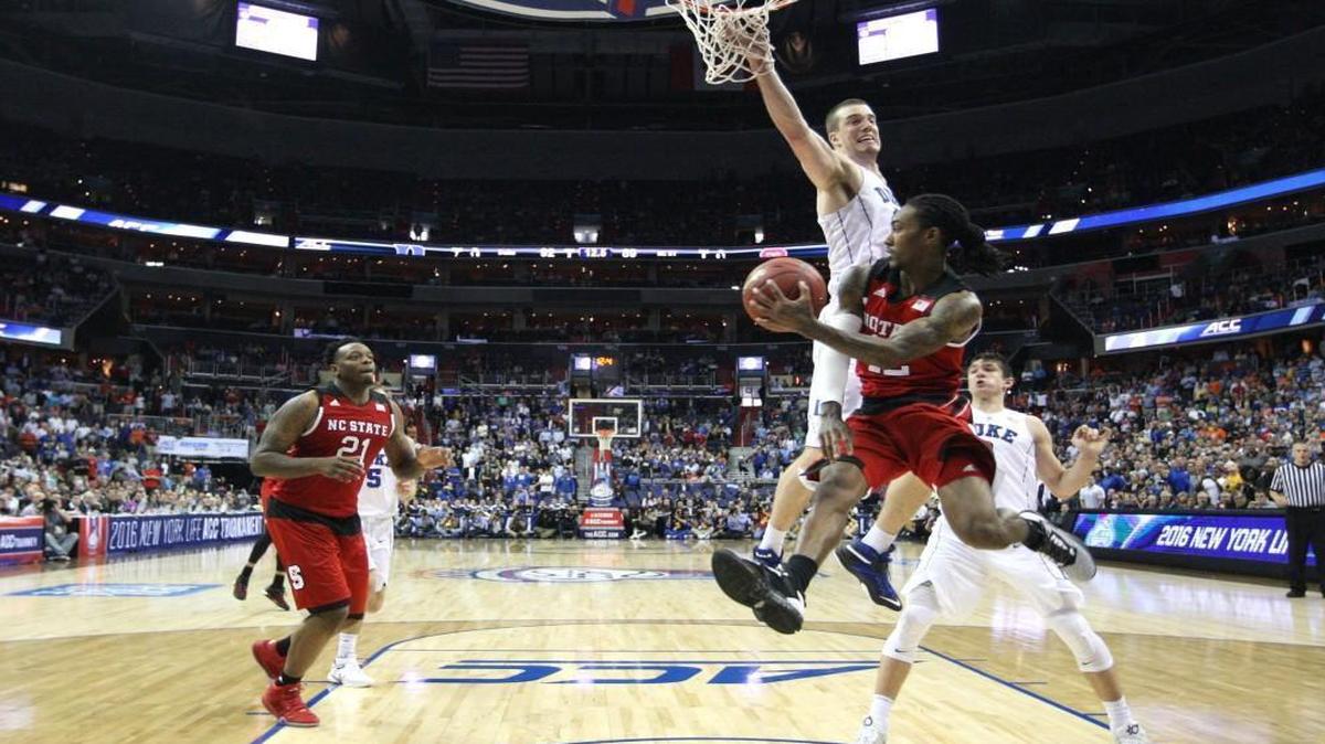 N.C. State's Cat Barber (12) tries to pass to BeeJay Anya (21) with 12 seconds left in the game during Duke's 92-89 victory over the Wolfpack in the second round of the ACC tournament at the Verizon Center in Washington. Anya could not handle the pass and Duke got possession of the ball.