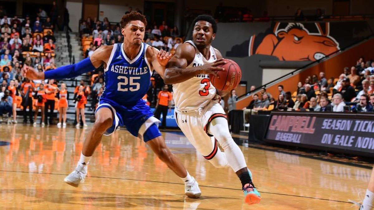 Campbell’s Chris Clemons drives past UNC Asheville’s MaCio Teague on Thursday at Gore Arena. Clemons, a former Millbrook star, had 23 points in a 64-57 loss.